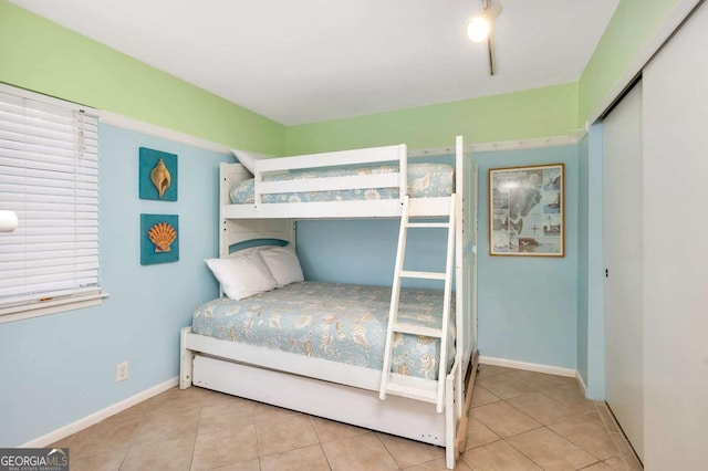 tiled bedroom featuring a closet