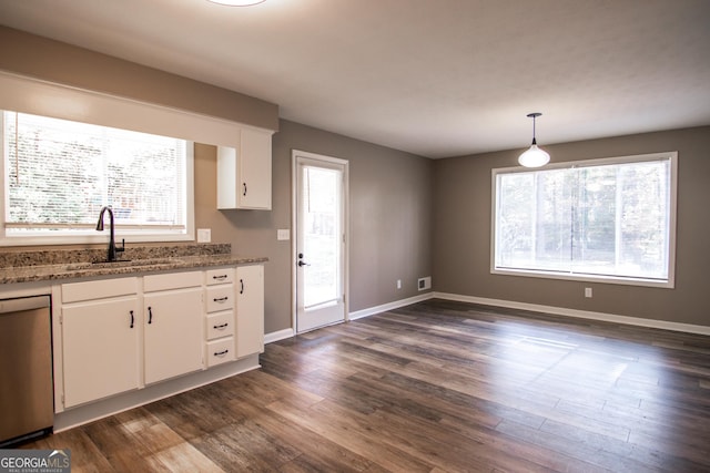 kitchen featuring dark wood-type flooring, sink, hanging light fixtures, stainless steel dishwasher, and white cabinetry