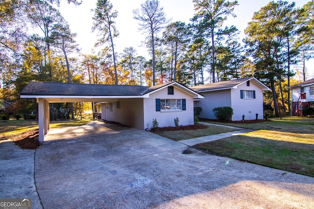 ranch-style home featuring a front yard and a carport