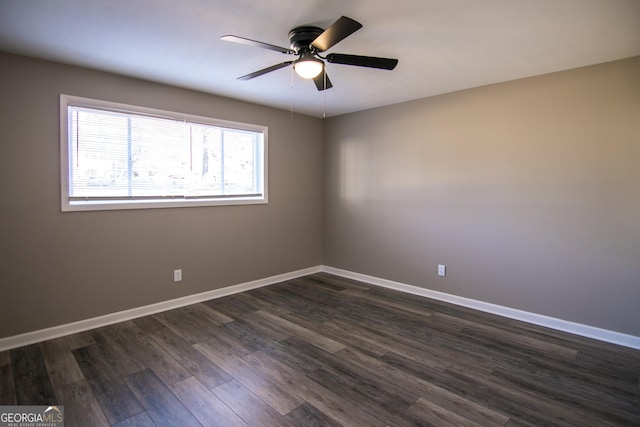 spare room featuring ceiling fan and dark hardwood / wood-style floors