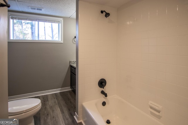 full bathroom with vanity, toilet, wood-type flooring, and tiled shower / bath combo