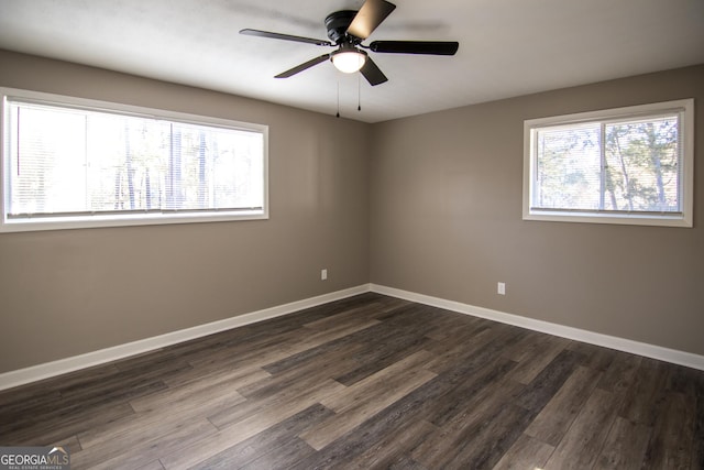 spare room featuring ceiling fan and dark wood-type flooring