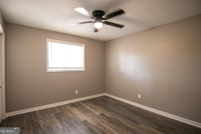 unfurnished room with dark hardwood / wood-style floors and ceiling fan