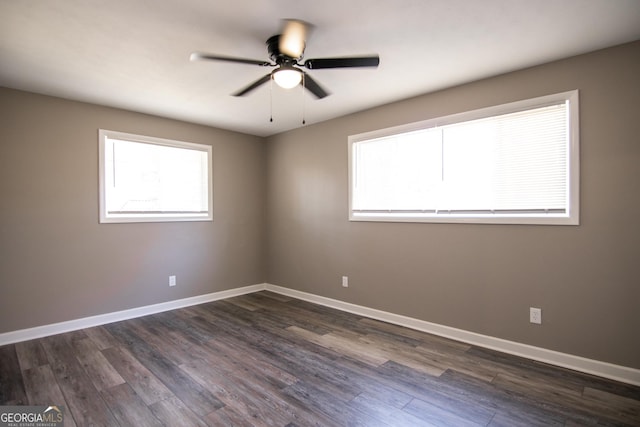 unfurnished room with ceiling fan and dark wood-type flooring