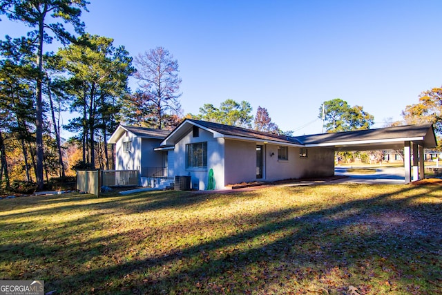 exterior space featuring a carport and a front lawn