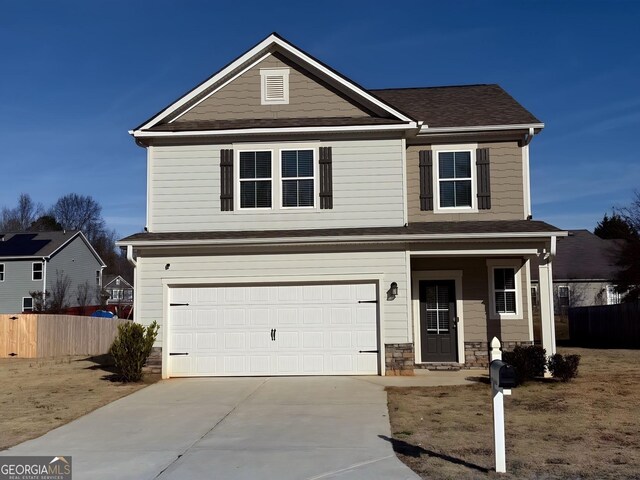 view of front of house with covered porch and a garage