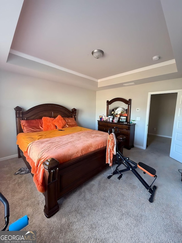 bedroom featuring carpet, a raised ceiling, and ornamental molding