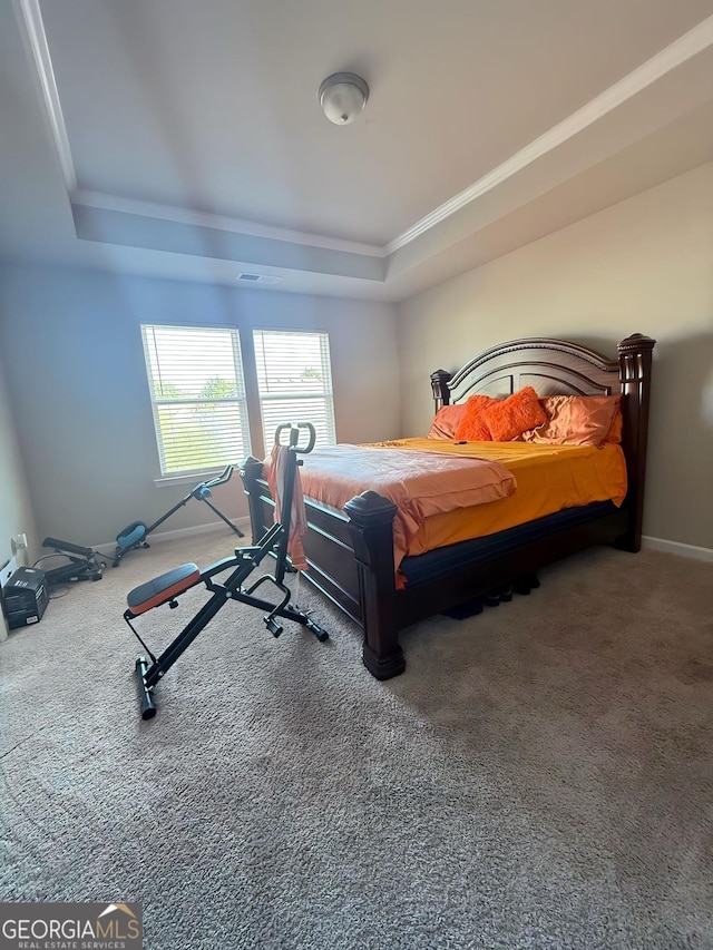 bedroom with carpet, a raised ceiling, and crown molding