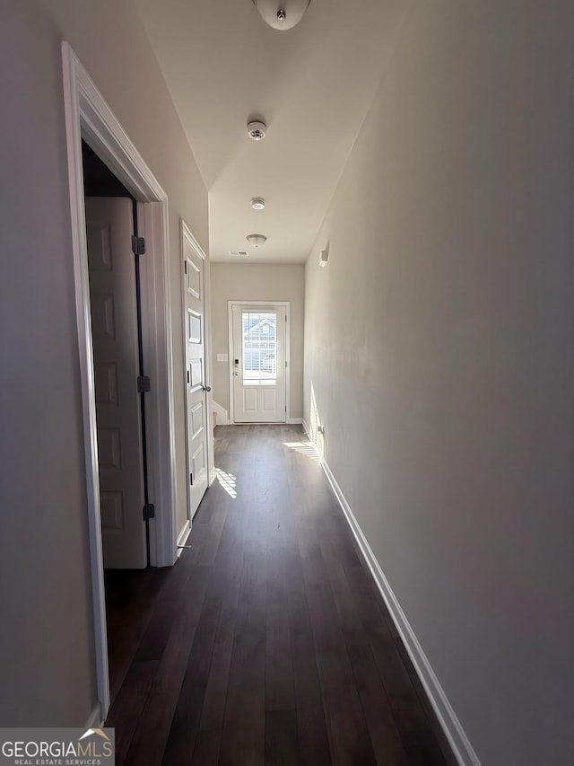 hallway featuring dark wood-type flooring