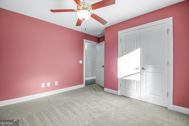 unfurnished bedroom with a closet, light colored carpet, and ceiling fan