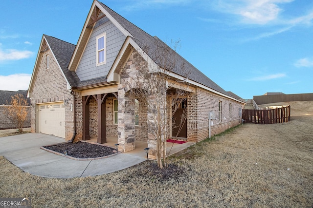 view of front of house featuring a porch, a front yard, and a garage