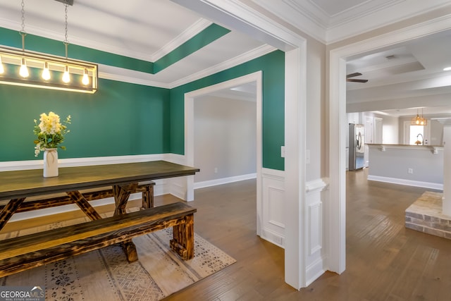 dining area with wood-type flooring, ceiling fan, and ornamental molding