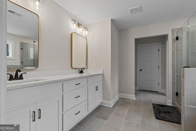 bathroom featuring vanity, tile patterned floors, and walk in shower