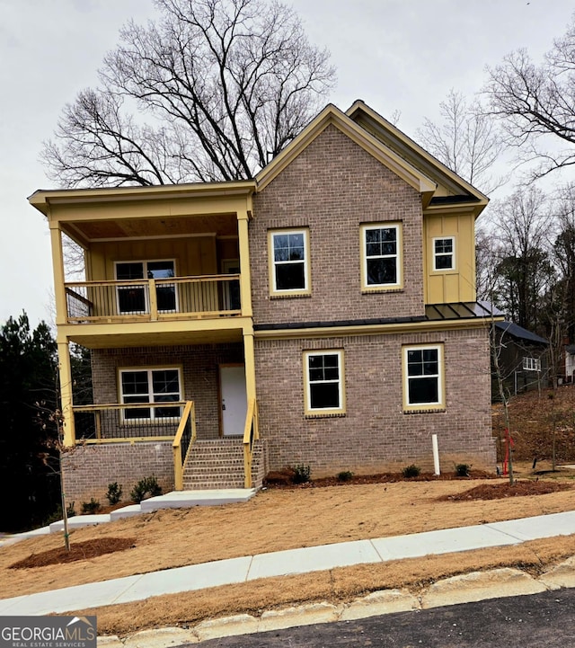 view of front of property featuring covered porch and a balcony