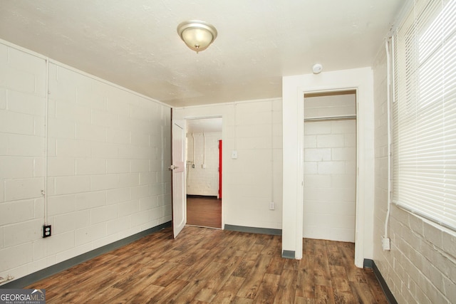 unfurnished bedroom featuring dark hardwood / wood-style flooring and a closet