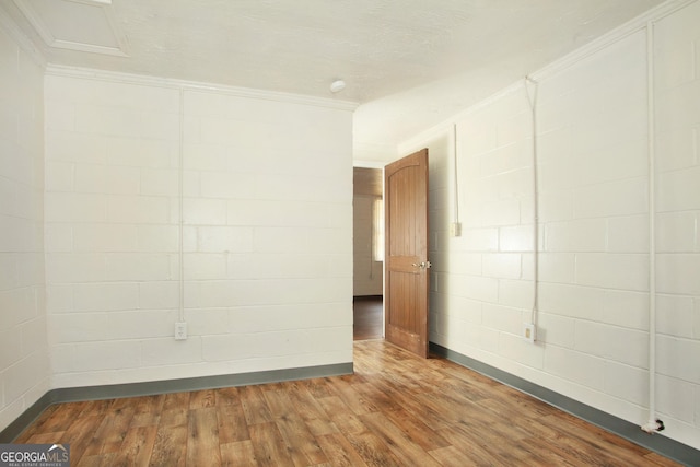 spare room with hardwood / wood-style flooring and ornamental molding