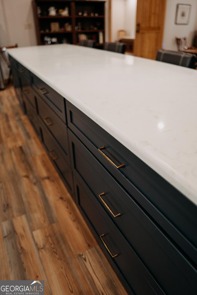 kitchen featuring dark brown cabinetry and light hardwood / wood-style flooring