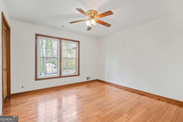 spare room with ceiling fan and light hardwood / wood-style flooring