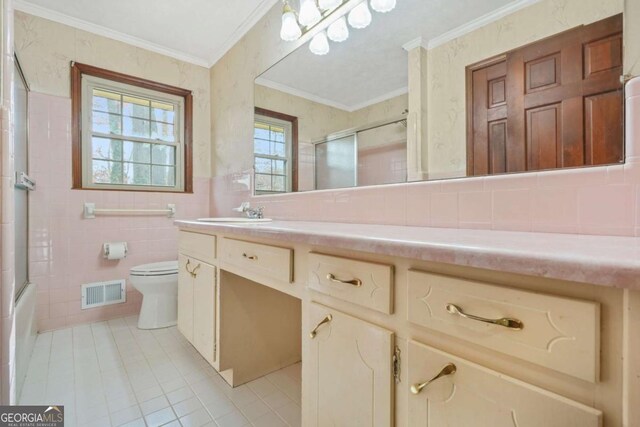 full bathroom with tile patterned flooring, toilet, vanity, tile walls, and ornamental molding