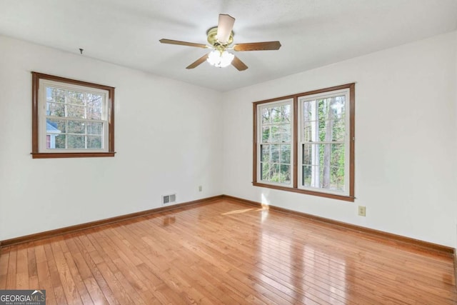 unfurnished room with light wood-type flooring and ceiling fan