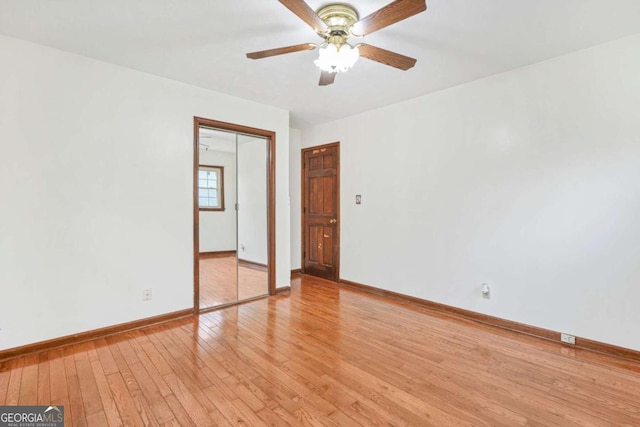 empty room with ceiling fan and light hardwood / wood-style floors