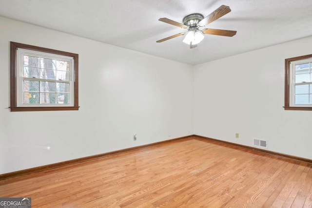 empty room featuring ceiling fan and light wood-type flooring