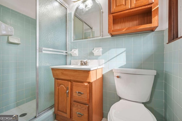 bathroom with tasteful backsplash, walk in shower, vanity, tile walls, and toilet