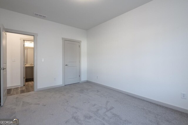 unfurnished bedroom with light colored carpet