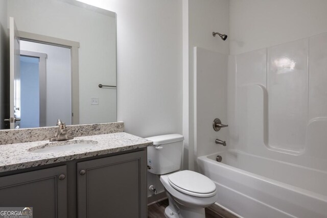 full bathroom featuring vanity, wood-type flooring,  shower combination, and toilet