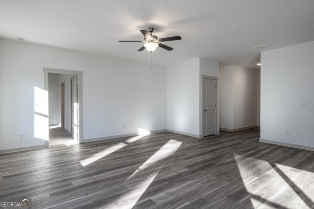 unfurnished room with dark hardwood / wood-style floors and ceiling fan