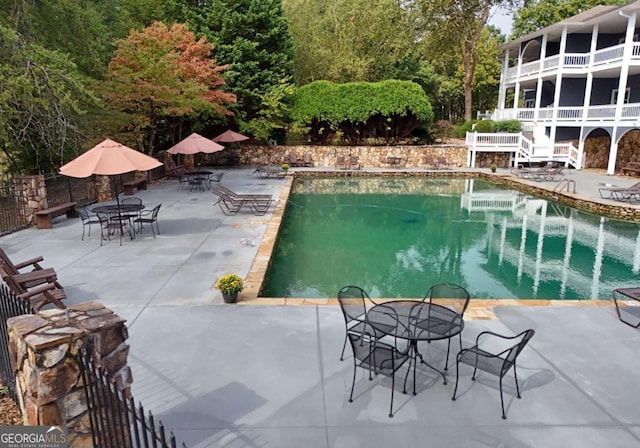 view of swimming pool featuring a patio area