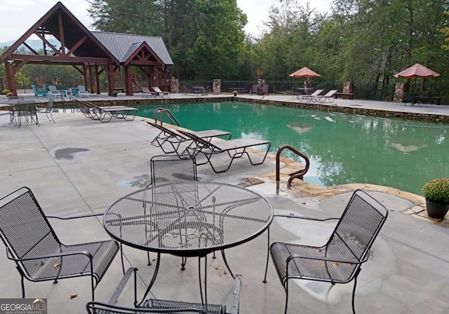 view of swimming pool featuring a gazebo and a patio area