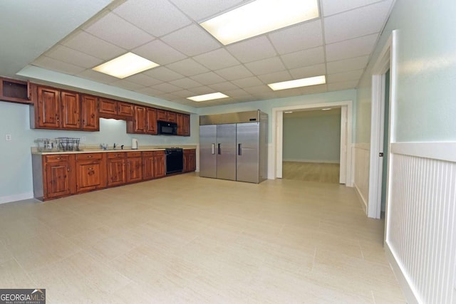 kitchen with stainless steel built in refrigerator, a drop ceiling, and sink