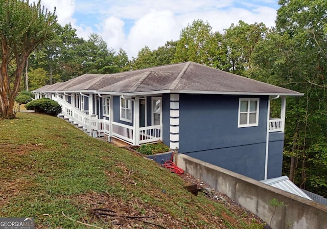 view of side of home featuring a yard