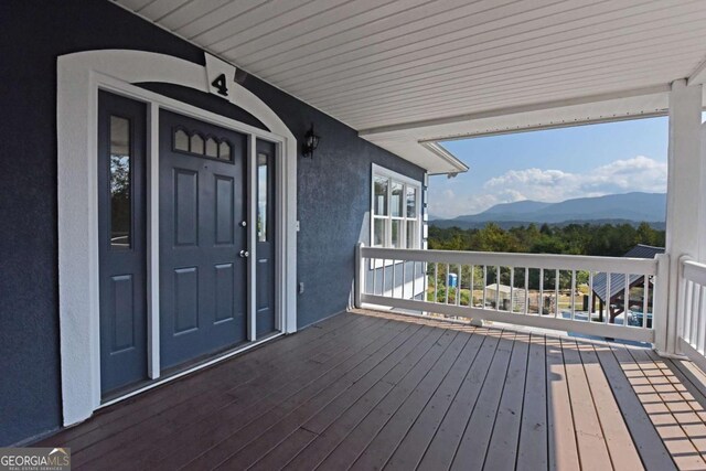 wooden terrace with a mountain view