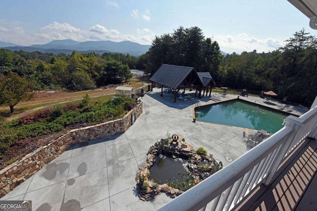 view of pool with a mountain view and a gazebo