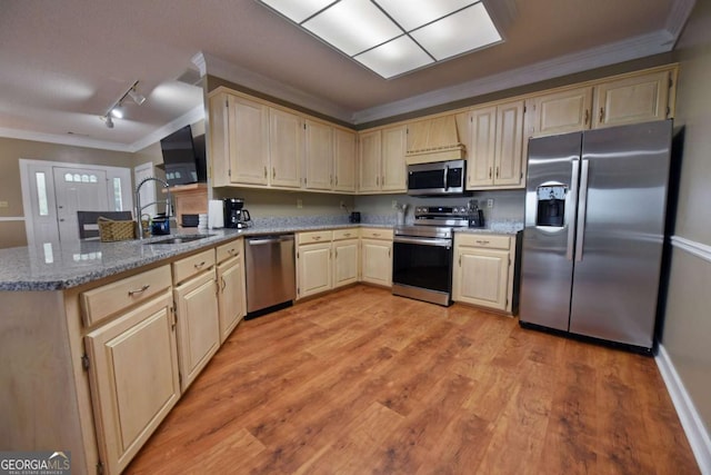 kitchen with sink, light stone counters, light hardwood / wood-style flooring, appliances with stainless steel finishes, and ornamental molding