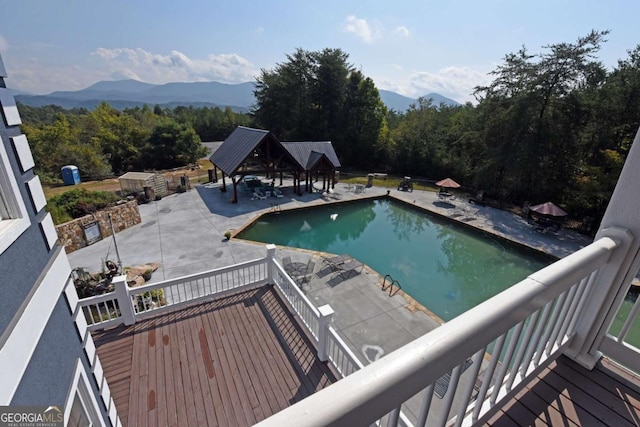 view of swimming pool with a gazebo and a mountain view