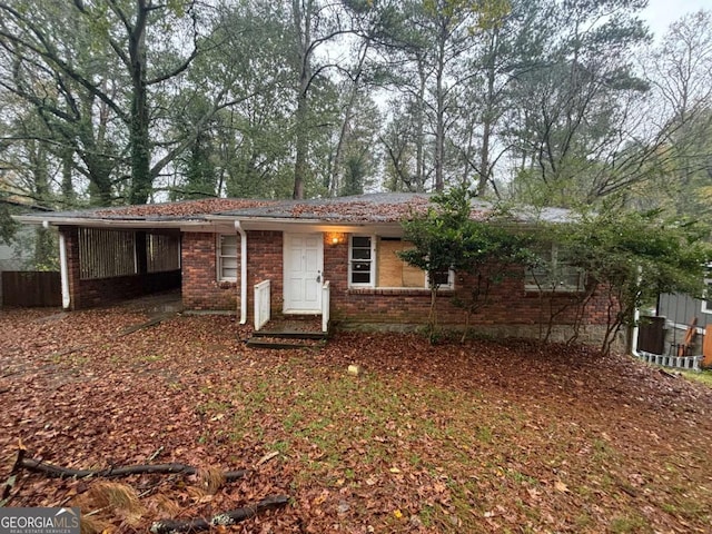 single story home featuring a carport