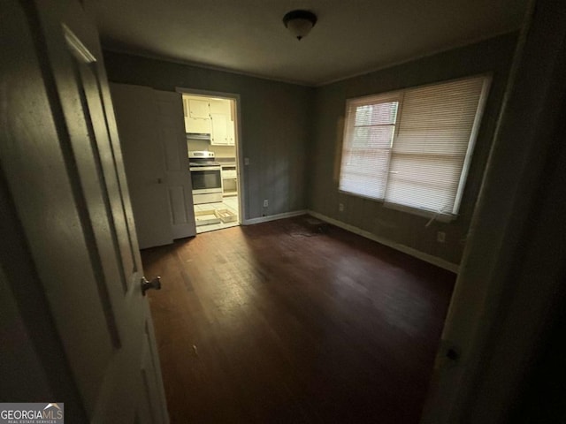 unfurnished room featuring dark wood-type flooring