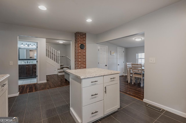 kitchen featuring sink, white cabinets, dark hardwood / wood-style floors, and a kitchen island