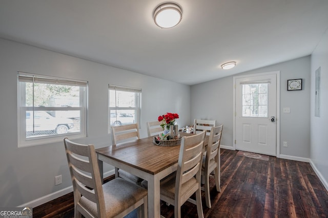 dining space featuring dark hardwood / wood-style flooring, plenty of natural light, and vaulted ceiling