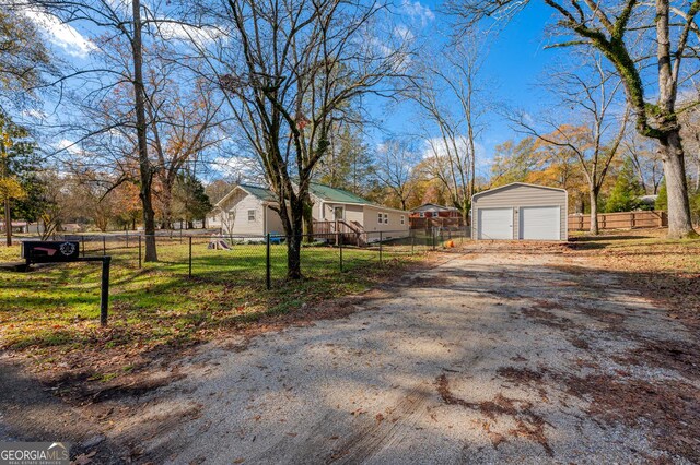 view of front of property featuring a garage and an outbuilding