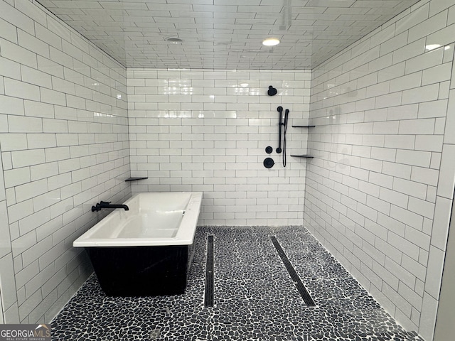 429 Deens Landing Rd, Baxley, GA 31513 - bathroom with a tub, a tile shower, and tile walls