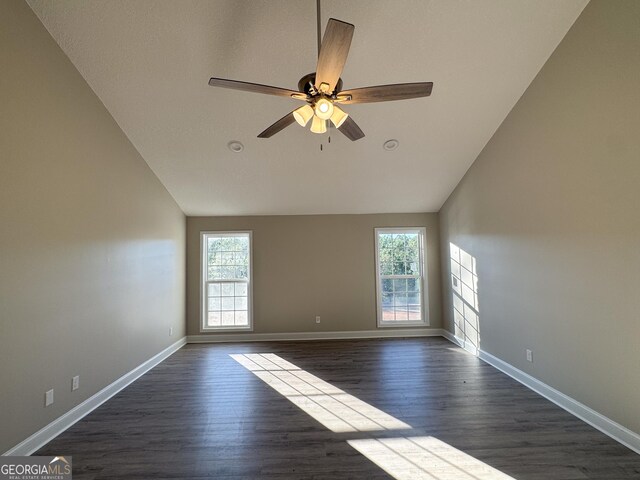 interior space with ceiling fan, dark hardwood / wood-style flooring, and high vaulted ceiling