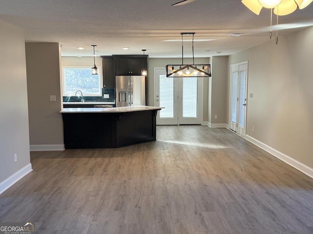 429 Deens Landing Rd, Baxley, GA 31513 - kitchen with stainless steel fridge, light countertops, wood finished floors, a sink, and baseboards