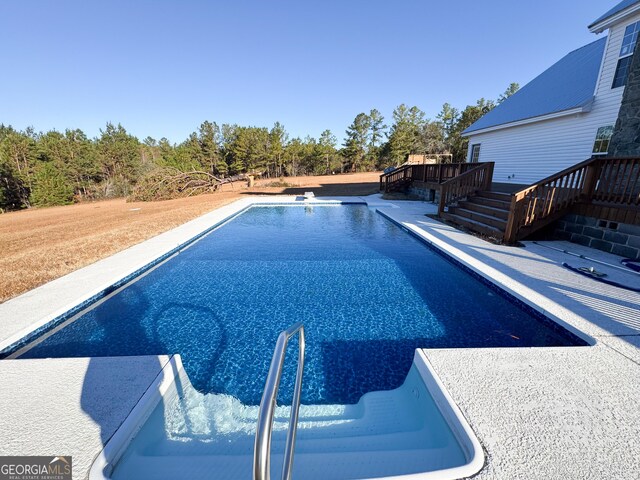 view of swimming pool featuring a deck