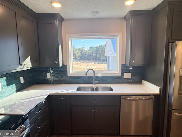 429 Deens Landing Rd, Baxley, GA 31513 - kitchen with stainless steel appliances, a sink, tasteful backsplash, and a textured ceiling