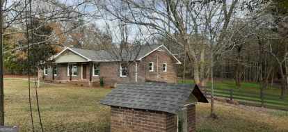 exterior space featuring a front yard and a storage shed