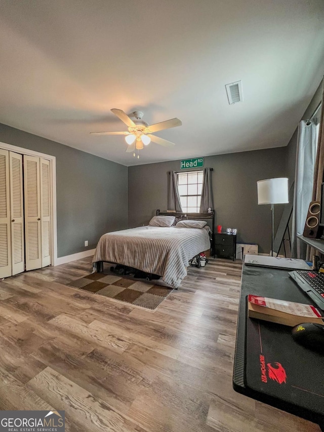 bedroom featuring hardwood / wood-style flooring and ceiling fan